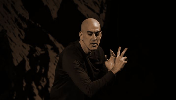 Performer in front of a projection-mapped mountain backdrop during Tirgan Festival at Meridian Hall Toronto